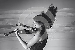 Girl, violin, wind, clouds