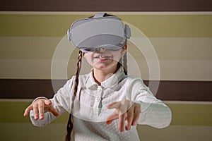 Girl with a virtual reality headset. The girl explores the world of virtual reality through video and games