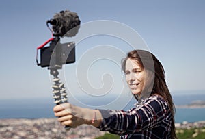 Girl Vlogging on Mountain Top photo