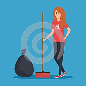 Girl volunteer with broom and trash bag