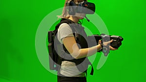 Girl in vr glasses looks around.Young woman wearing virtual reality glasses. Enthusiastic VR glasses simulating shooting