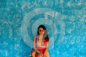 Girl waiting in front of the blue wall in Sayulita