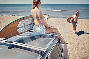 girl waiting for the high waves on beach - Sporty people with surf boards on the beach - Extreme sport concept.