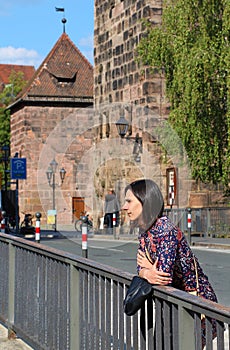 Girl is waiting somebody on the bridge