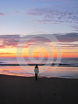 A girl waiting for sunrise on the beach