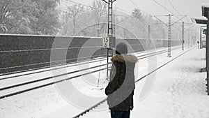 Girl waiting the train in winter time.
