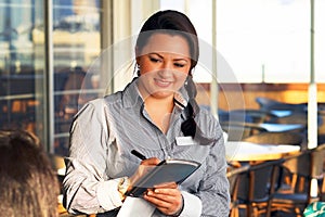 The girl waitress take a customer`s order