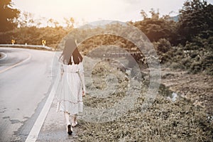 Girl walk away at roadside