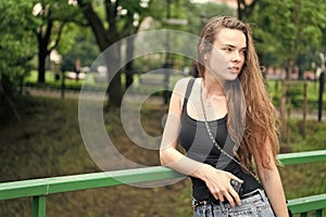 Girl walk park green nature background. Woman stop to enjoy nature peaceful environment during walk. Find time to relax