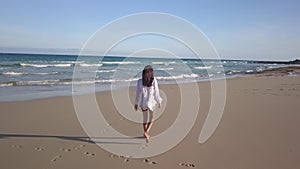 Girl walking alone on the beach