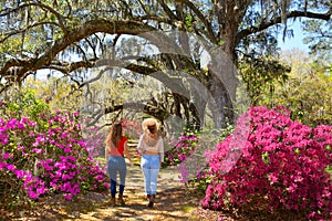 Girl walking alone in beautiful garden on spring trip.