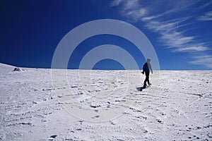 Girl walking alone on snow field
