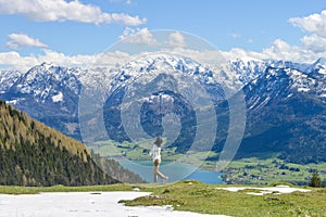 Girl walking around edge of Schafberg mountain, Austria