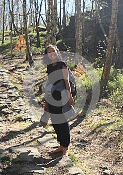 Girl walking barefoot on old stone path