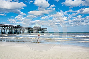 Girl walking on the beautiful beach on summer vacation.