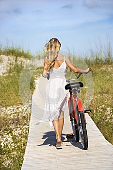 Girl Walking Bike on Boardwalk