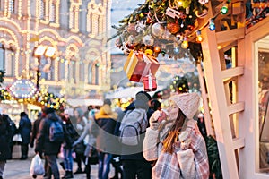 Girl walking on Christmas Market on Red Square in Moscow