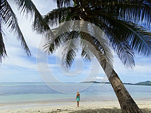 Girl walking on a coral beach. Tropical Paradise - Fiji - islands on South Pacific