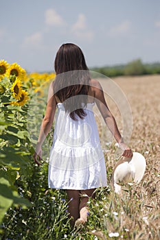 Girl walking in a cropland