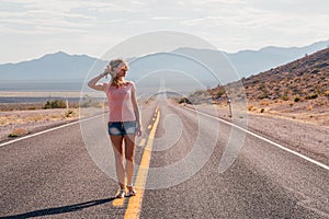 Girl walking down the endless road