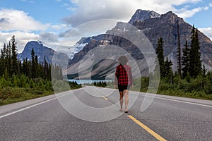 Girl walking down a scenic road in the Canadian Rockies