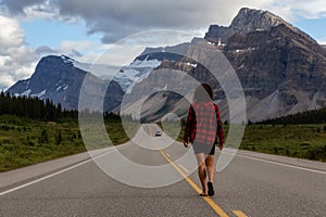 Girl walking down a scenic road in the Canadian Rockies