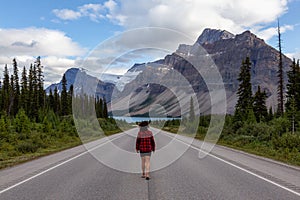 Girl walking down a scenic road in the Canadian Rockies