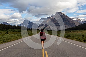 Girl walking down a scenic road in the Canadian Rockies