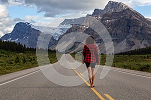 Girl walking down a scenic road in the Canadian Rockies