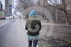 A girl is walking down the street.