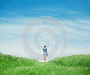 Girl walking on grass field