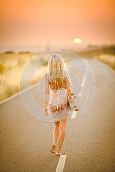 Girl walking with her skateboard