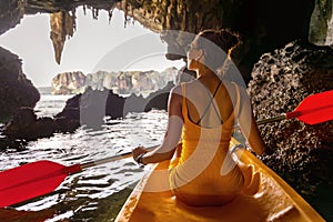 Girl is walking on kayak or canoe at sea bay