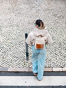 Girl Walking on Lisbon\'s White Pavement Crossing