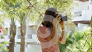 Girl walking in the park and take pictures