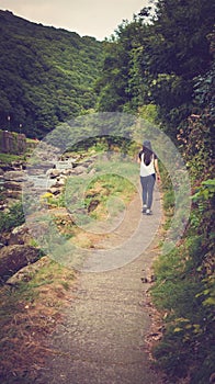 Girl walking in the path of East Lyn River