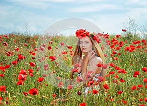 Girl walking in poppy field