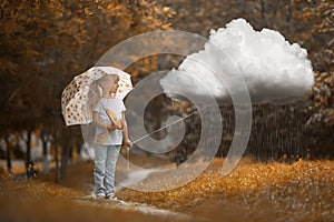 A girl walking the rainy cloud at autumn time on the orange background