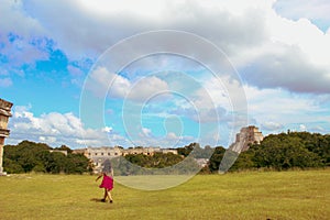 Girl walking in ruins of the ancient city in Uxmal, Yucatan, Mexico photo