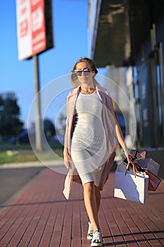 Girl walking with shopping bags. Concept of woman shopping.Shopper. Sales