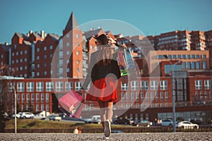 The girl walking with shopping on city streets