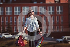 The girl walking with shopping on city streets