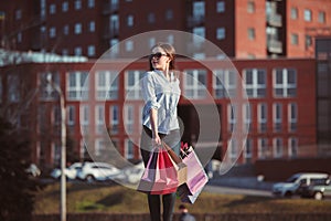 The girl walking with shopping on city streets