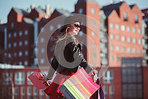 The girl walking with shopping on city streets