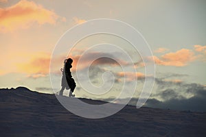 Girl walking in snow silhouette