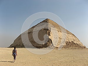 A girl walking towards the Bent Pyramid, Dahshur, Egypt