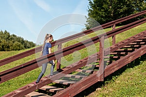 Girl walking up wooden stairs