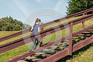 Girl walking up wooden stairs