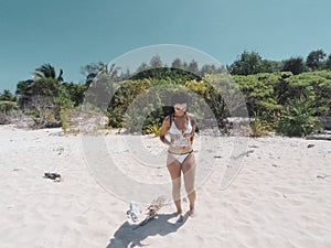 Girl walking on white sandy beach of Balabac island in Philippines photo