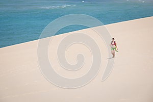 Girl walking on the white dunes on the Bazaruto Island